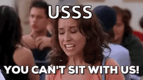 A Woman Is Sitting In A Crowd Of People And Crying . GIF