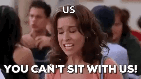 A Woman Is Sitting In A Crowd Of People And Saying `` You Can 'T Sit With Us '' . GIF