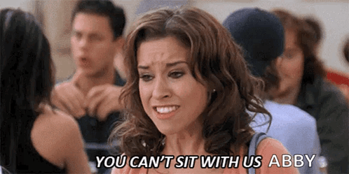 A Woman Is Sitting In A Crowd Of People And Says `` You Can 'T Sit With Us Abby '' GIF