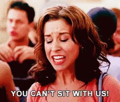 A Woman Is Sitting In A Crowd Of People And Says `` You Can 'T Sit With Us '' . GIF