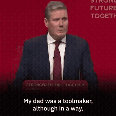 A Woman Is Sitting In A Crowd With The Words " My Dad Was A Toolmaker Although In A Way " GIF