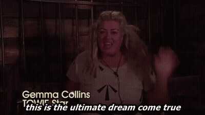 A Woman Is Sitting In A Dark Room With Her Hands In The Air . GIF