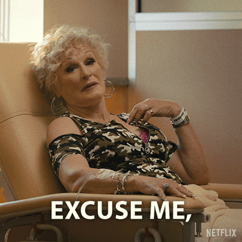 A Woman Is Sitting In A Hospital Chair With The Words Excuse Me Netflix Written Below Her GIF