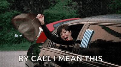 A Woman Is Sitting In A Limousine With Her Arms In The Air And Holding A Key . GIF