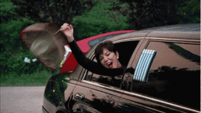 A Woman Is Sitting In A Limousine With Her Arms Out The Window And Holding An Umbrella . GIF