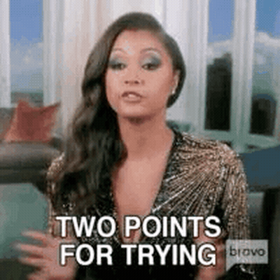 A Woman Is Sitting In A Living Room With Her Arms Outstretched And Says `` Two Points For Trying '' . GIF