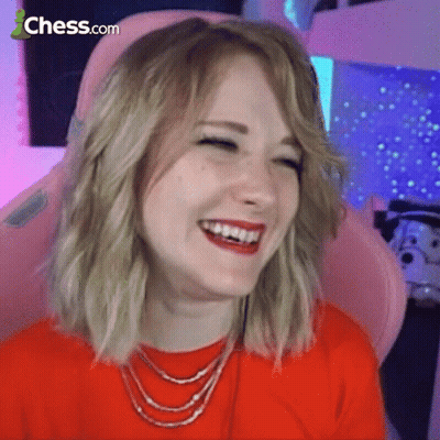 A Woman Is Sitting In A Pink Chair And Laughing With Chess.com In The Corner GIF