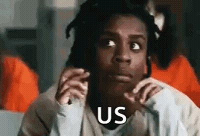 A Woman Is Sitting In A Prison Cell With Her Hands On Her Face And Says `` Us '' . GIF
