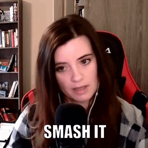 A Woman Is Sitting In A Red Chair In Front Of A Microphone . GIF