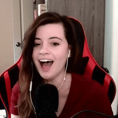 A Woman Is Sitting In A Red Chair With Her Mouth Open GIF
