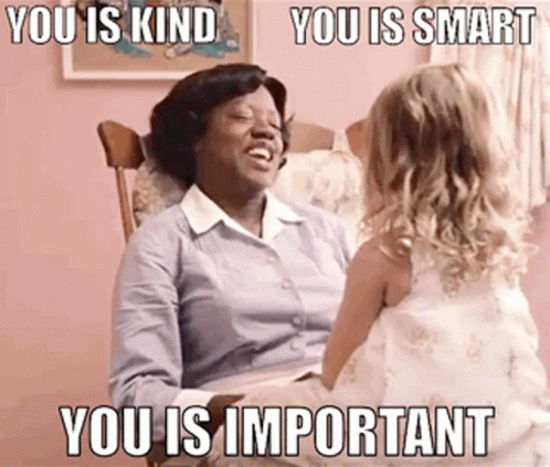 A Woman Is Sitting In A Rocking Chair Talking To A Little Girl Who Is Wearing A White Dress GIF