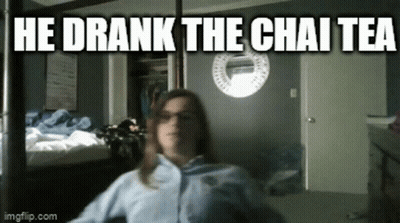 A Woman Is Sitting In A Room With The Words He Drank The Chai Tea Written Above Her GIF