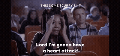 A Woman Is Sitting In A Theater Watching A Movie And Saying `` Lord I 'M Gonna Have A Heart Attack '' GIF