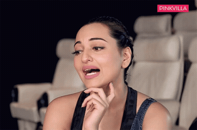 A Woman Is Sitting In A Theatre With A Pinkvilla Logo Behind Her GIF