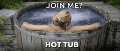 A Woman Is Sitting In A Wooden Hot Tub With The Words `` Join Me ? Hot Tub '' . GIF