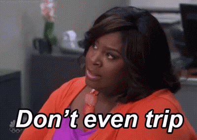 A Woman Is Sitting In An Office With The Words `` Don 'T Even Trip '' Written On The Screen . GIF