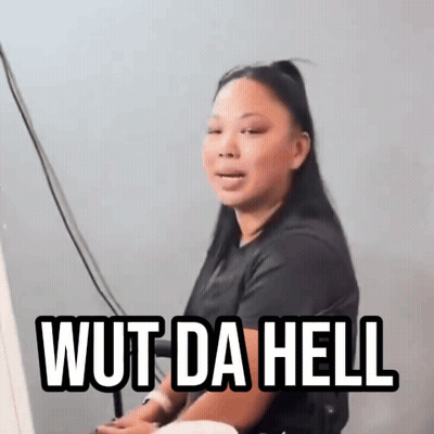 A Woman Is Sitting In Front Of A Computer With The Words Wut Da Hell Written On Her Face GIF