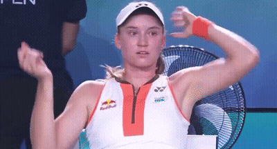 A Woman Is Sitting In Front Of A Fan With Her Arms Outstretched . GIF