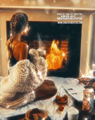 A Woman Is Sitting In Front Of A Fireplace With The Website Gina101creative.com At The Bottom Of The Image GIF