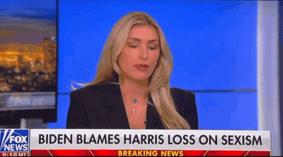 A Woman Is Sitting In Front Of A Fox News Breaking News Sign . GIF