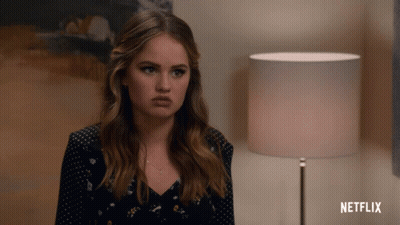 A Woman Is Sitting In Front Of A Lamp And A Netflix Logo GIF
