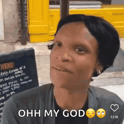 A Woman Is Sitting In Front Of A Menu Board And Says " Ohh My God " GIF