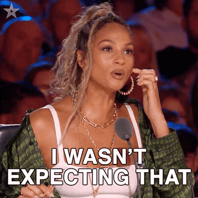 A Woman Is Sitting In Front Of A Microphone And Says I Wasn 'T Expecting That GIF