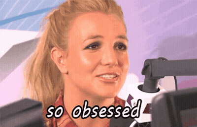 A Woman Is Sitting In Front Of A Microphone And Says " So Obsessed " GIF