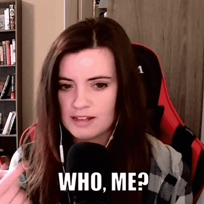 A Woman Is Sitting In Front Of A Microphone And Says Who Me GIF