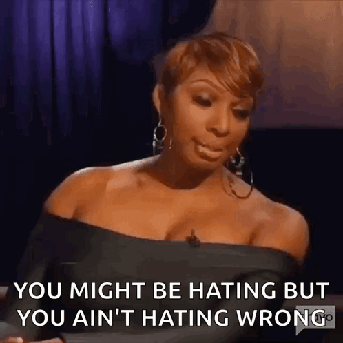A Woman Is Sitting In Front Of A Microphone And Says You Might Be Hating But You Ain 'T Hating Wrong GIF