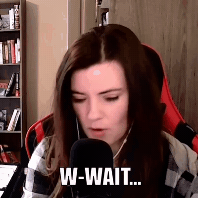A Woman Is Sitting In Front Of A Microphone And Talking Into It While Wearing Headphones . GIF