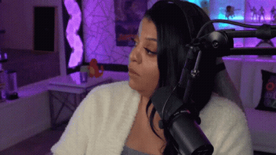 A Woman Is Sitting In Front Of A Microphone . GIF