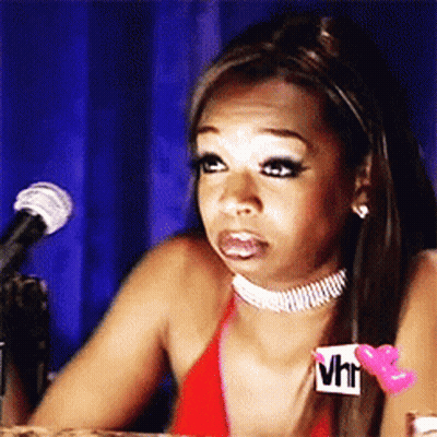 A Woman Is Sitting In Front Of A Microphone Wearing A Choker That Says Vh1 On It GIF