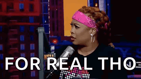 A Woman Is Sitting In Front Of A Microphone With The Words `` For Real Tho '' Written On The Screen . GIF