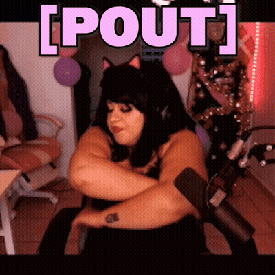 A Woman Is Sitting In Front Of A Microphone With The Words [ Pout ] Written Above Her GIF