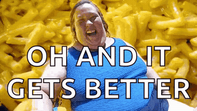 A Woman Is Sitting In Front Of A Pile Of Macaroni And Cheese And Laughing . GIF