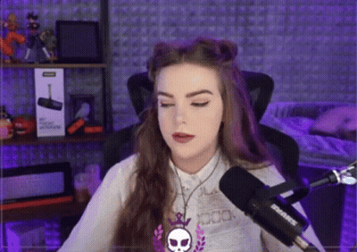 A Woman Is Sitting In Front Of A Shure Microphone In A Recording Studio . GIF