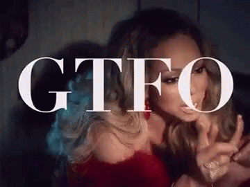 Woman Sitting In Front Of GTFO Sign GIF