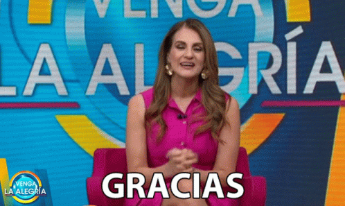 A Woman Is Sitting In Front Of A Sign That Says La Alegria GIF