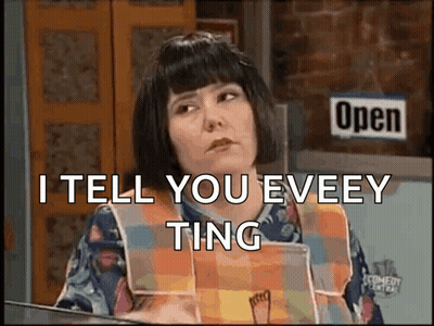 A Woman Is Sitting In Front Of A Sign That Says Open GIF