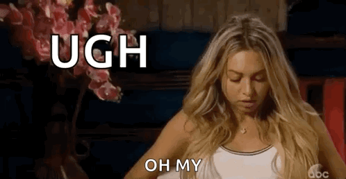 A Woman Is Sitting In Front Of A Vase Of Flowers And Making A Funny Face And Saying `` Ugh Oh My '' . GIF