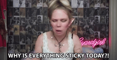 A Woman Is Sitting In Front Of A Wall With A Collage Of Pictures And Says `` Why Is Everything Sticky Today ? '' GIF