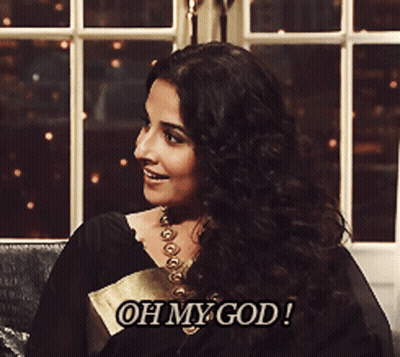 A Woman Is Sitting In Front Of A Window And Says " Oh My God " GIF