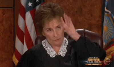 A Woman Is Sitting In Front Of An American Flag And A Sign That Says Survivor Tonight GIF