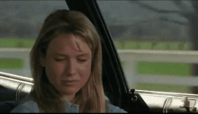 A Woman Is Sitting In The Back Seat Of A Car With Her Eyes Closed And Crying . GIF