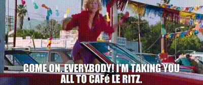 A Woman Is Sitting In The Driver 'S Seat Of A Red Car And Talking On A Cell Phone . GIF