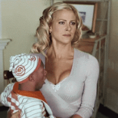 A Woman Is Sitting Next To A Man Wearing A Hat With A Target On It GIF