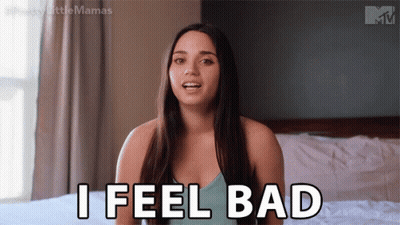 A Woman Is Sitting On A Bed And Saying " I Feel Bad " GIF