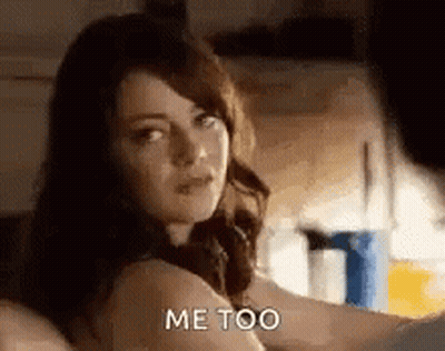 A Woman Is Sitting On A Bed Talking To A Man . GIF