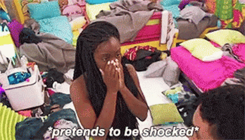 A Woman Is Sitting On A Bed With Her Hands On Her Face And The Words `` Pretends To Be Shocked '' Above Her . GIF